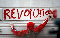 A protester sprays a message on a government building as thousands of student protest against tuition fees at Whitehall in London, Wednesday, Nov.24,2010. Thousands of British students protested Wednesday against government plans to triple tuition fees, two weeks after a similar demonstration sparked a small riot. (AP Photo/Matt Dunham)