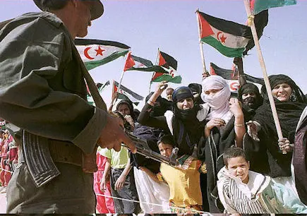 Sahraoui women and children welcome UN Special Envoy for the Western Sahara James Baker at the Smara refugee camp in southwestern Algeria 27 April. The former American state secretary visited the camp to meet leaders of the Polisario Front of the Arab Democratic Sahraoui Republic on the last leg of his mission to restart the peace process for the region, stalled for five years.