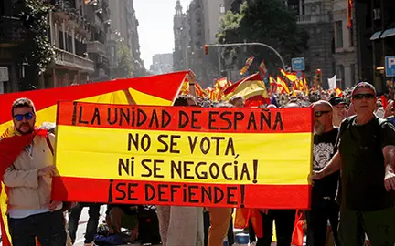 People hold a Spanish flag which reads "The unity of Spain can not be voted on or negotiated, it must be defended" during a pro-union demonstration organised by the Catalan Civil Society organisation in Barcelona, Spain October 8, 2017. REUTERS/Eric Gaillard