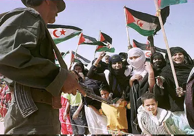 Sahraoui women and children welcome UN Special Envoy for the Western Sahara James Baker at the Smara refugee camp in southwestern Algeria 27 April. The former American state secretary visited the camp to meet leaders of the Polisario Front of the Arab Democratic Sahraoui Republic on the last leg of his mission to restart the peace process for the region, stalled for five years.